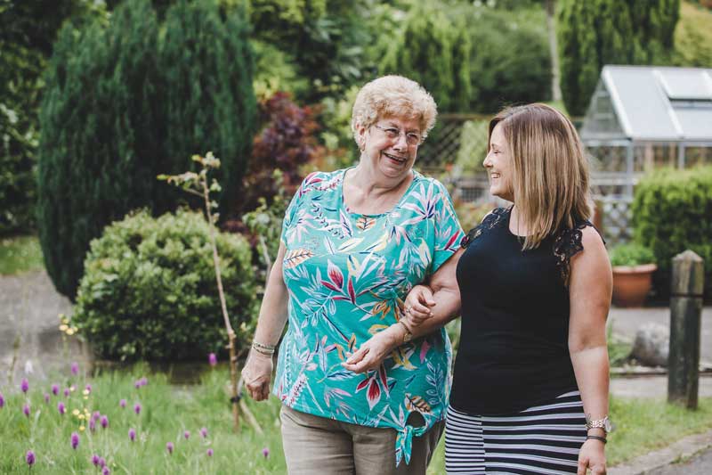Photo of Bradeley village. Customer Services Advisor Maria Scarlett with customer in the garden