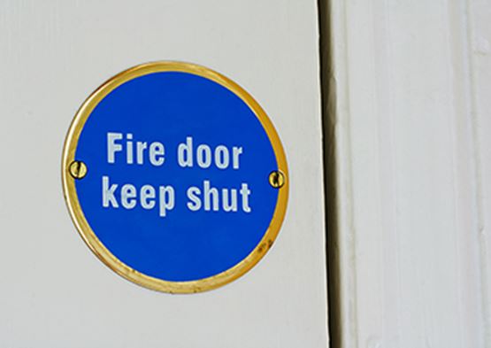 Fire door sign on white door