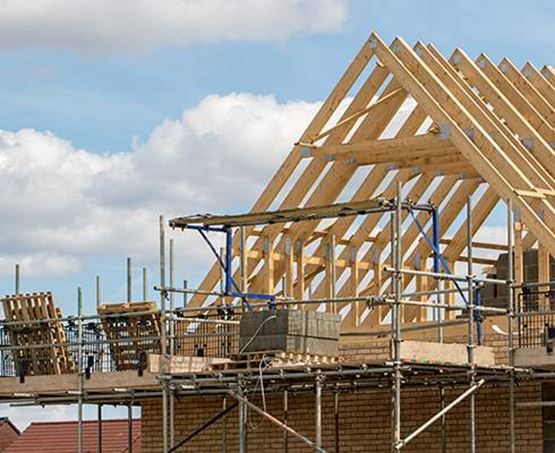 The pointed roof of a house being constructed