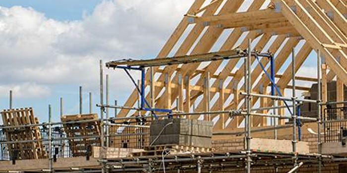 The pointed roof of a house being constructed