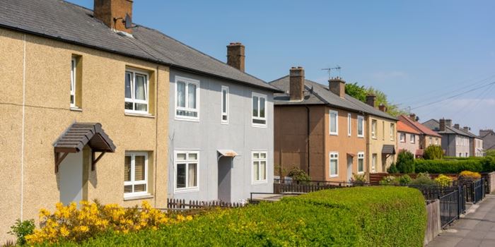 Semi-detached houses line a leafy street