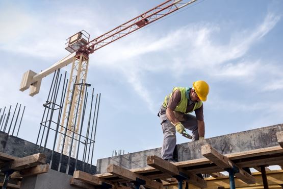 Worker in yellow hard hat on a construction site