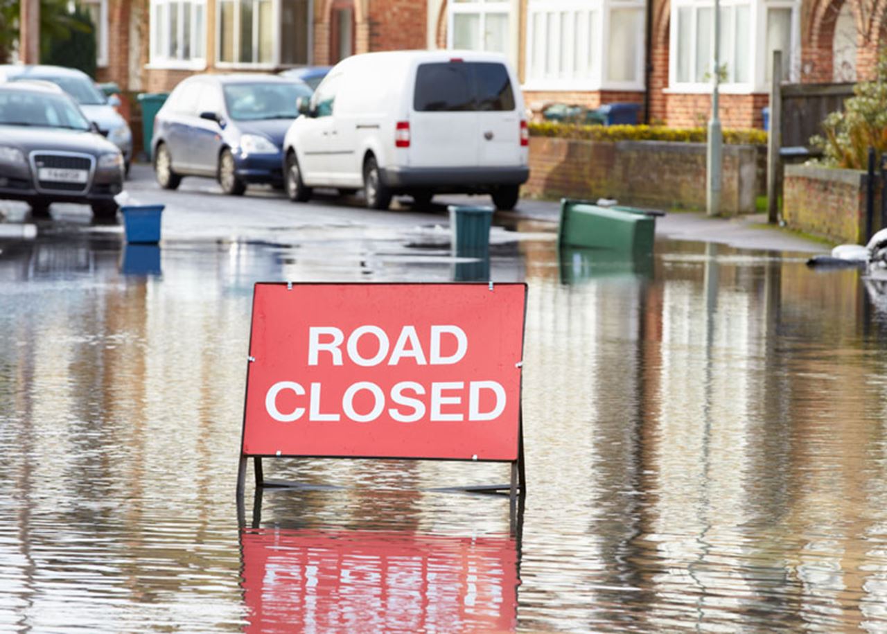 Flooded road with 'road closed' sign