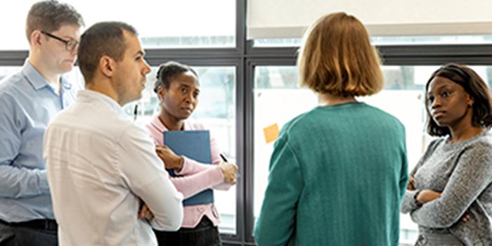 Colleagues talking near a window