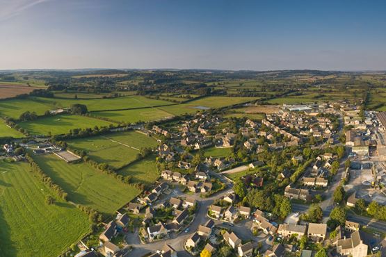 Aerial view of village surrounded by fields