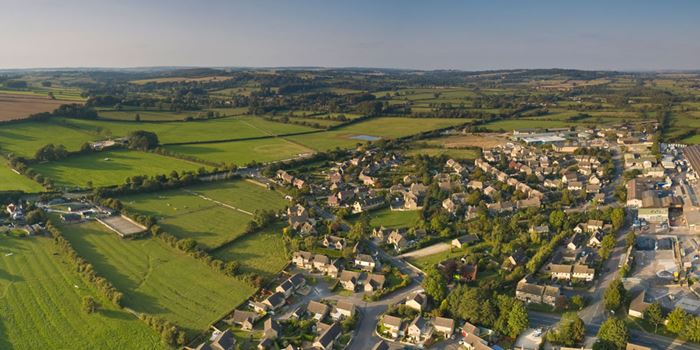 Aerial view of village surrounded by fields