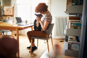 Woman with dog sat on her lap