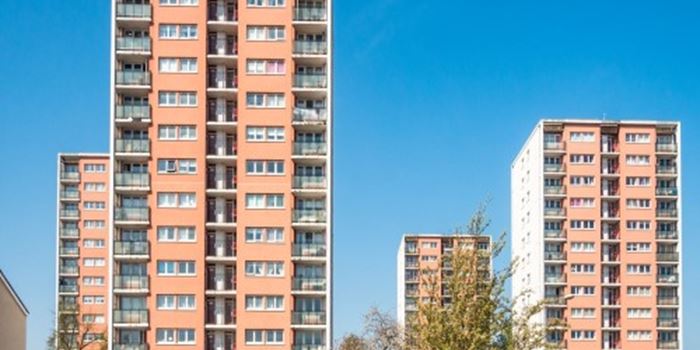 four pink high rise buildings against blue sky